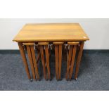 A nest of five teak tables CONDITION REPORT: The large table to which the smaller