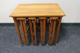 A nest of five teak tables CONDITION REPORT: The large table to which the smaller