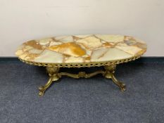 An oval onyx coffee table on ornate brass twin pedestal base CONDITION REPORT:
