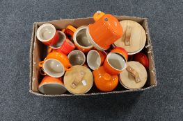 A box containing Le Creuset kitchen ware to include soup pots, mugs, pepper cellar,