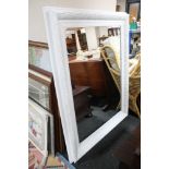 A painted white traditional style mirror,