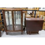 A mid century walnut Oriental style display cabinet together with a drop leaf table