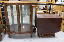 A mid century walnut Oriental style display cabinet together with a drop leaf table