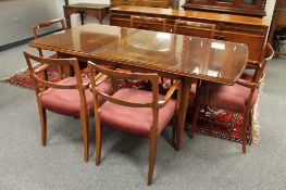 A mid 20th century extending dining room table and six carver armchairs, 182 cm x 91.