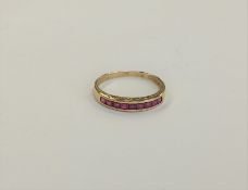 A 14ct gold ruby half eternity ring,