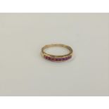 A 14ct gold ruby half eternity ring,