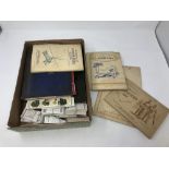 An early twentieth century album of world stamps together with an album of cigarette cards by