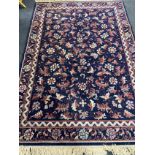 A fringed machine made Persian style carpet on blue ground CONDITION REPORT: 171 cm