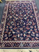 A fringed machine made Persian style carpet on blue ground CONDITION REPORT: 171 cm