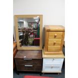 A pine three drawer bedside chest together with two further bedside chests and an oak effect mirror