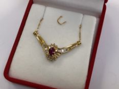 A 10ct gold ruby and diamond pendant on 18ct gold chain