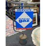 An enamelled Camping Gaz Service International sign on stand