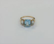 A 10ct gold diamond and topaz ring,