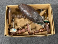 A box of carved hardwood wall mask, carved figure of a crocodile, wooden candlesticks,