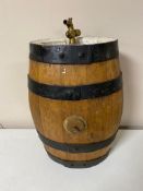 An oak coopered sherry barrel with brass tap