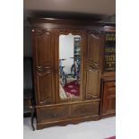 A late Victorian mahogany mirror door wardrobe, width 141 cm, with matching mirrored dressing table,