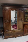 A late Victorian mahogany mirror door wardrobe, width 141 cm, with matching mirrored dressing table,