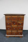 An Eastern hardwood twelve drawer chest