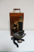 A black metal and brass Watson microscope in fitted mahogany box together with assorted accessories