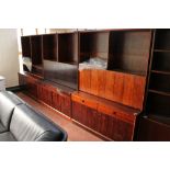 A three piece mid century Danish bookcase fitted with cupboards and drawers beneath