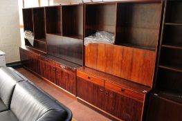 A three piece mid century Danish bookcase fitted with cupboards and drawers beneath