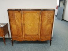 An inlaid walnut triple door side cabinet,