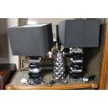 Two two-tone metal table lamps and shades and a further lamp