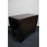 A 20th century oak drop leaf table CONDITION REPORT: 90cm long by 51cm wide by 76cm