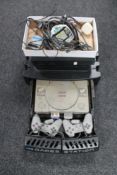 A Logik 3 game station stand containing Playstation and Playstation controllers together with a