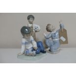 Three Nao figures; boy kneeling,