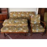 A mid century teak framed armchair in floral fabric together with a two-piece teak seating unit