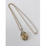 A 14ct gold gem-set locket and chain, 7.9g gross.