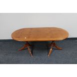 An oval yew wood twin pedestal coffee table CONDITION REPORT: 120cm long by 60cm