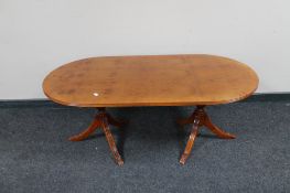 An oval yew wood twin pedestal coffee table CONDITION REPORT: 120cm long by 60cm