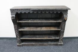 A set of antique oak heavily carved bookshelves