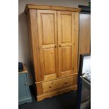A pine double door wardrobe fitted a drawer CONDITION REPORT: Height 192.5 cm.