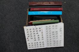 A box of nine albums and folders of stamps and first day covers