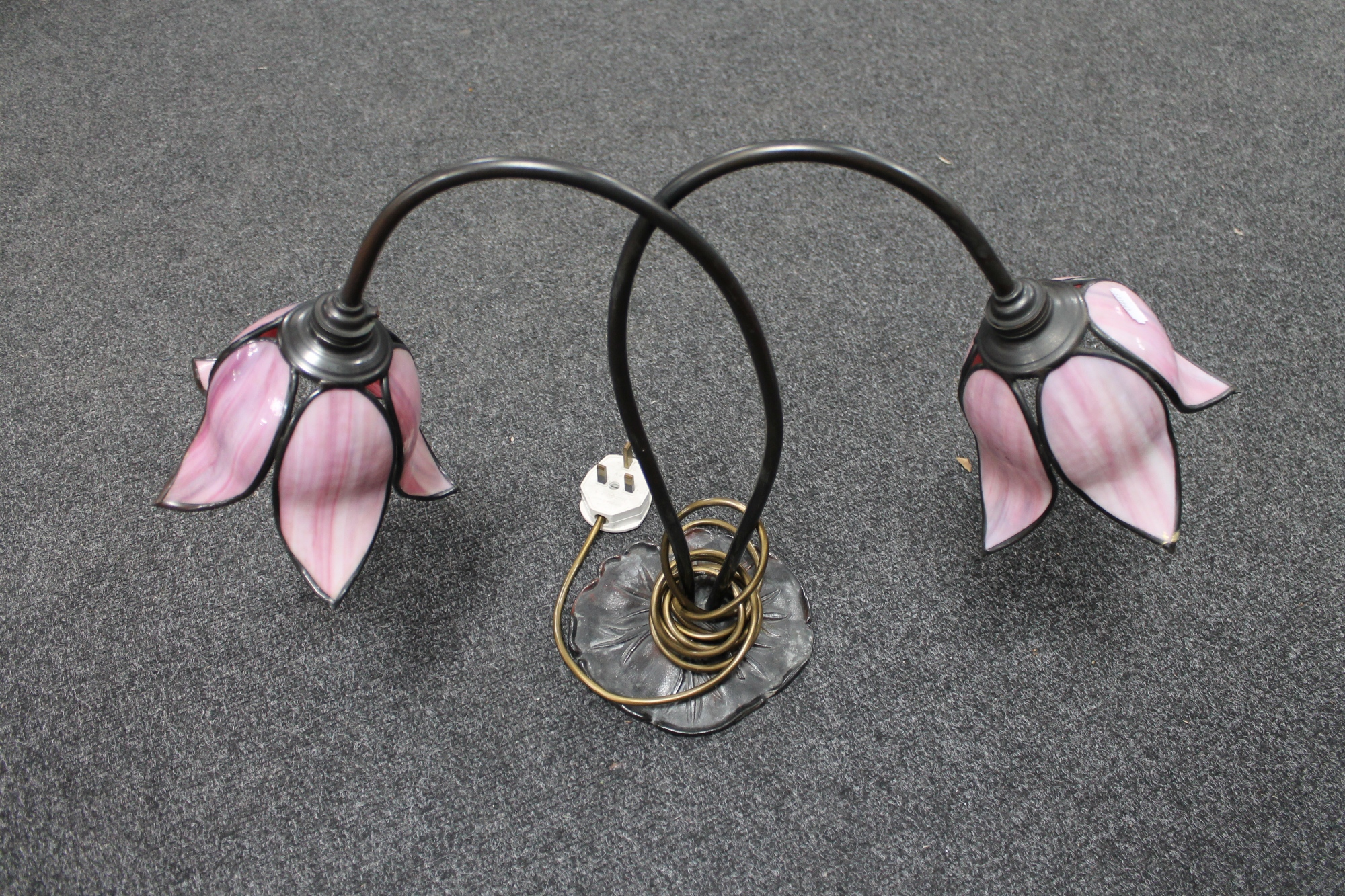 A contemporary Art Deco style two-way table lamp with leaded tulip shades