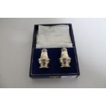 A boxed pair of silver salt and pepper sifters