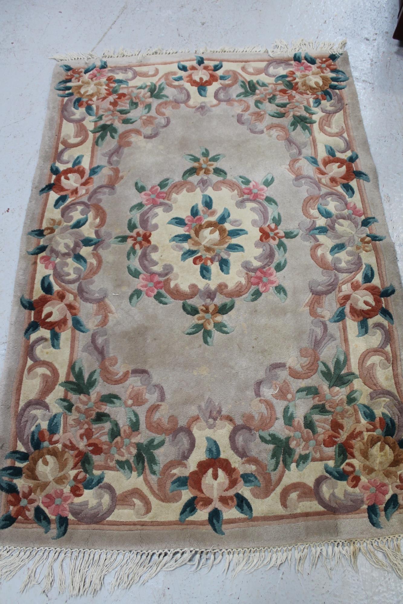 A fringed Chinese floral embossed rug