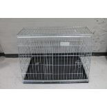 A folding metal dog cage width 97 cm