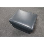 A blue leather storage footstool