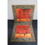 A pair of framed wall art panels depicting African figures