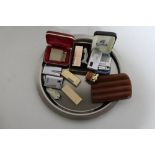 A plated tray containing a collection of assorted gas lighters to include Calibri, Ronson,