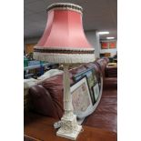 A cream carved table lamp with tassel shade