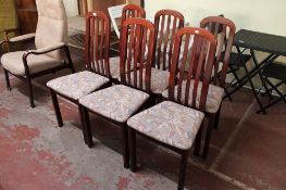 A set of six rail backed dining chairs in a mahogany finish