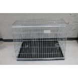 A folding metal dog cage width 97 cm