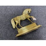 An antique brass door stop in the form of a horse
