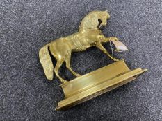 An antique brass door stop in the form of a horse