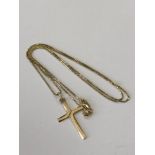 A 14ct gold crucifix and chain, 3.8g. CONDITION REPORT: The chain length 51 cm.